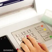 Banking facility ATM keypad with user entering PIN
