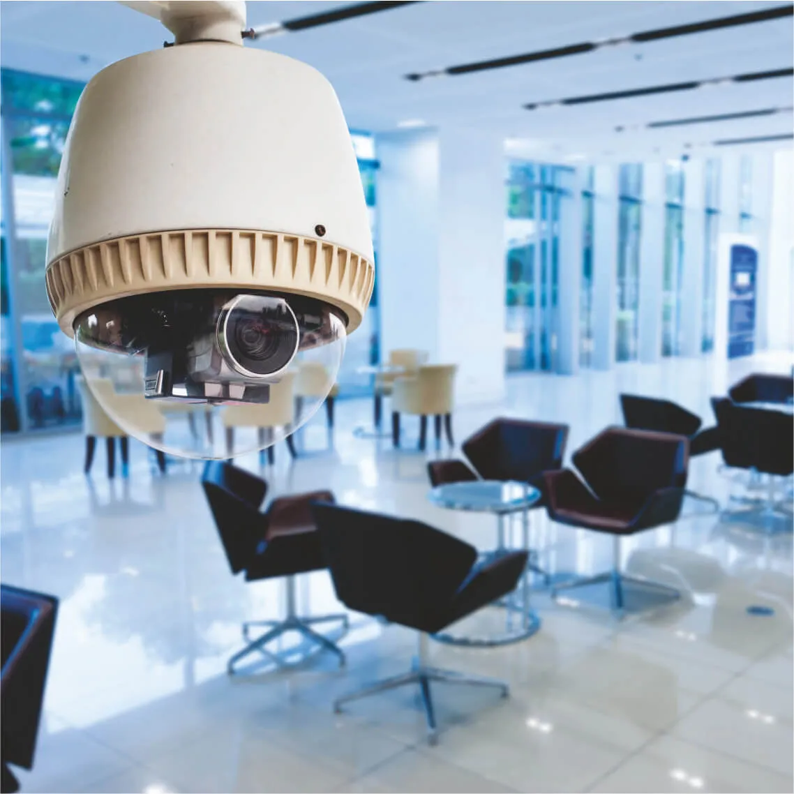 Ceiling-mounted dome CCTV security camera in the office lobby