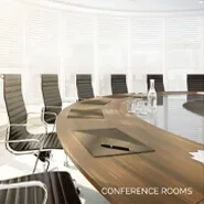 Modern conference room with large wooden table and leather chairs